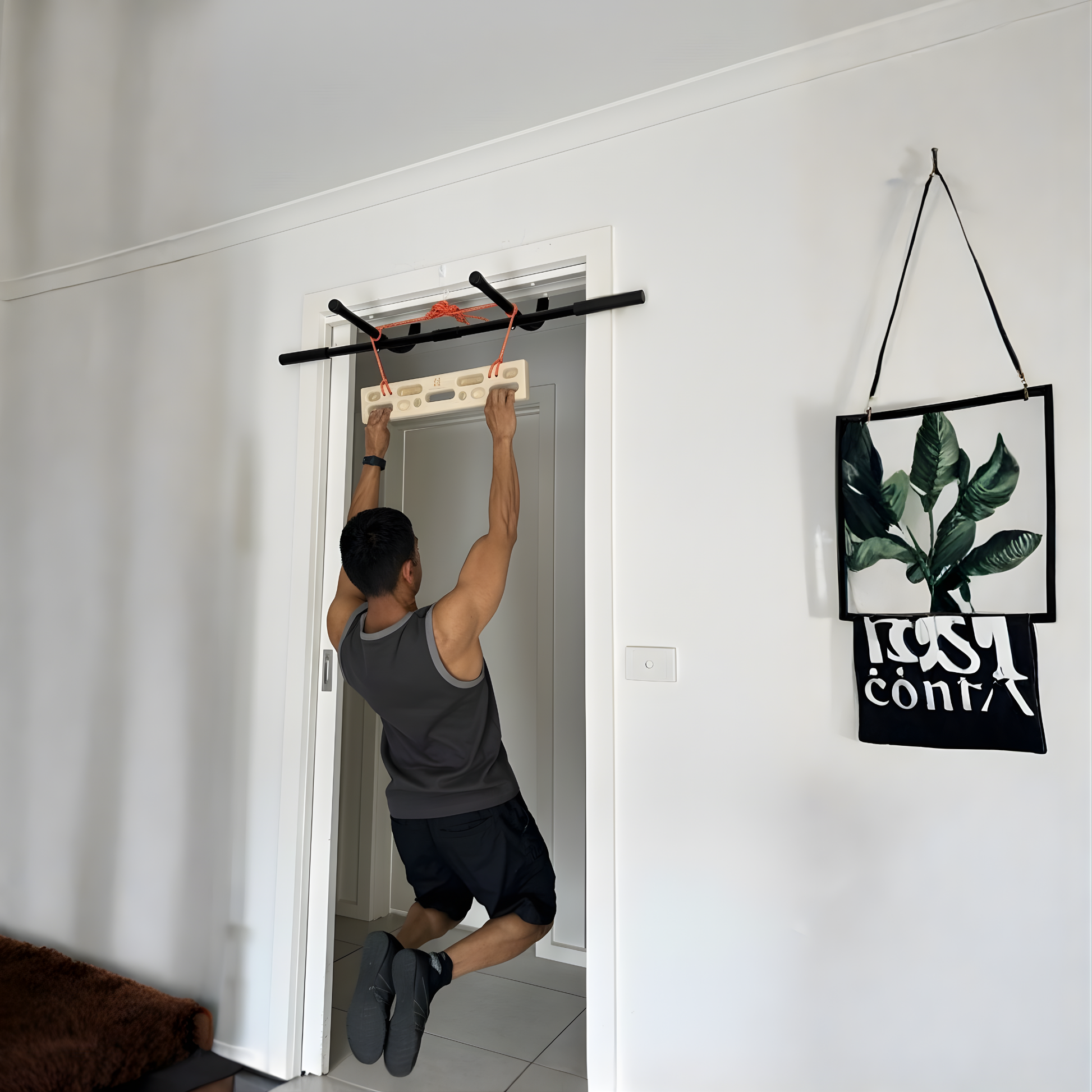 A person using the portable climbing hangboard on a doorframe pull up bar